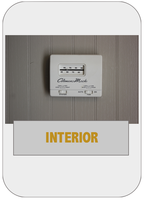 A white thermostat mounted to the wall.