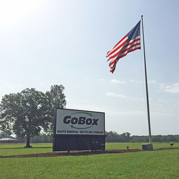 A large american flag flying in the sky.